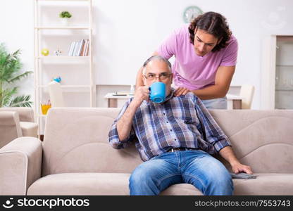 The young student and his old grandpa at home. Young student and his old grandpa at home