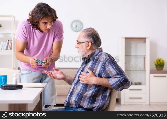 The young student and his old grandpa at home. Young student and his old grandpa at home