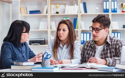 The young student and teacher during tutoring lesson. Young student and teacher during tutoring lesson