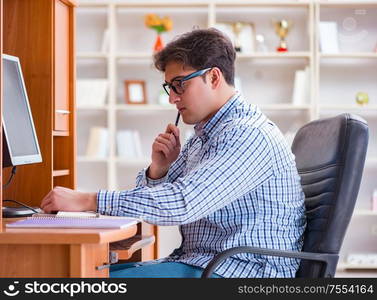 The young student at computer table. Young student at computer table