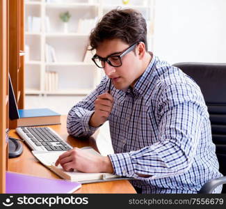 The young student at computer table. Young student at computer table
