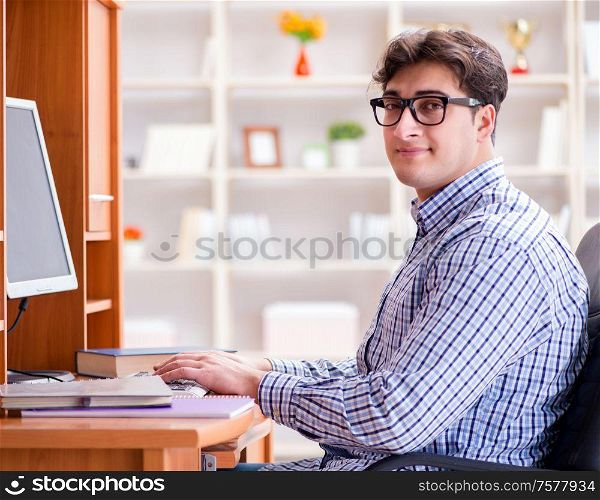 The young student at computer table. Young student at computer table