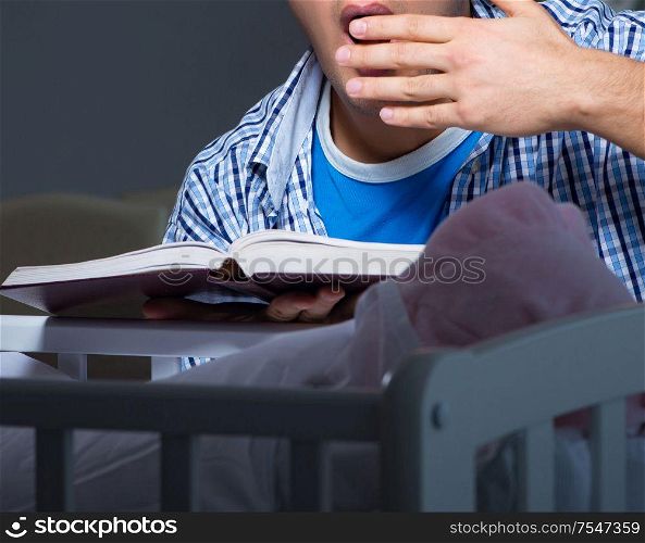 The young student doing homework and looking after newborn baby. Young student doing homework and looking after newborn baby