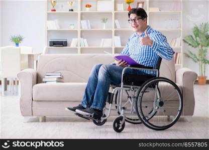 The young student on wheelchair in disability concept. Young student on wheelchair in disability concept