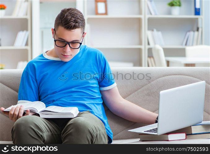 The young student preparing for exams studying at home on a sofa. Young student preparing for exams studying at home on a sofa