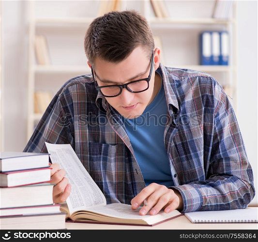 The young student preparing to school exams with books. Young student preparing to school exams with books