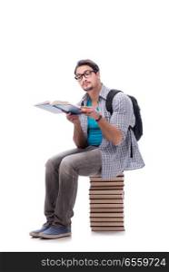 The young student sitting on top of book stack on white. Young student sitting on top of book stack on white