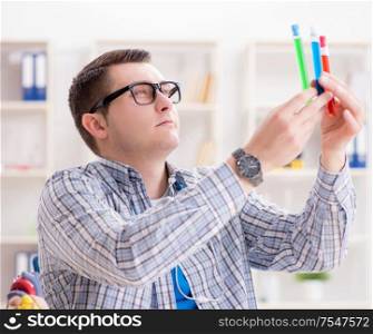 The young student studying chemistry in university. Young student studying chemistry in university
