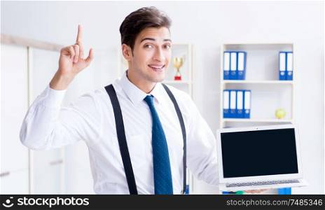 The young stylish businessman working in the office. Young stylish businessman working in the office