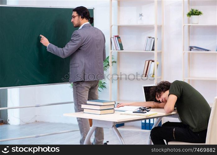 The young teacher and student in the classroom . Young teacher and student in the classroom 