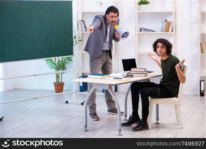 The young teacher and student in the classroom. Young teacher and student in the classroom
