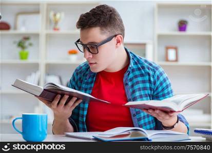 The young teenager preparing for exams studying at a desk indoors. Young teenager preparing for exams studying at a desk indoors