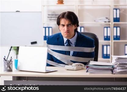 The young tied male employee in the office. Young tied male employee in the office