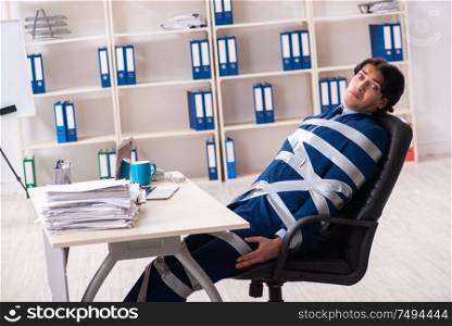 The young tied male employee in the office. Young tied male employee in the office