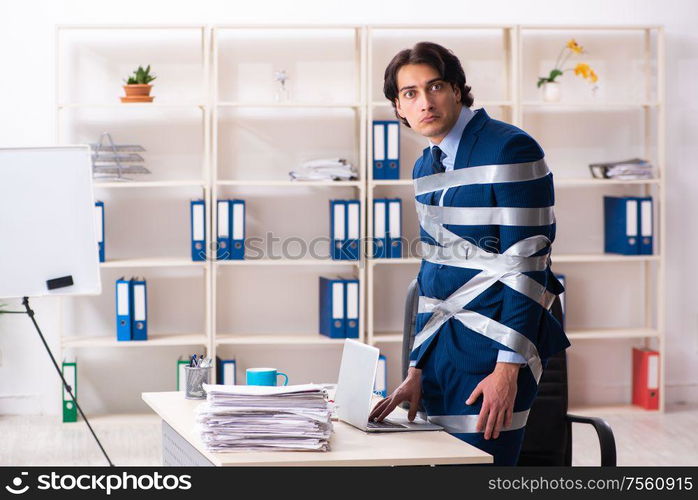 The young tied male employee in the office. Young tied male employee in the office