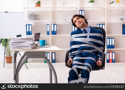 The young tied male employee in the office. Young tied male employee in the office