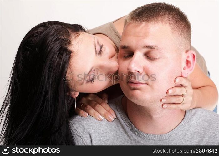 The young woman and the man in passionate embraces couple gray wall