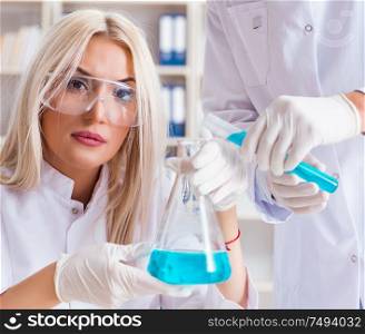 The young woman chemist working in clinic lab. Young woman chemist working in clinic lab
