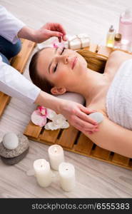 The young woman during spa procedure in salon. Young woman during spa procedure in salon