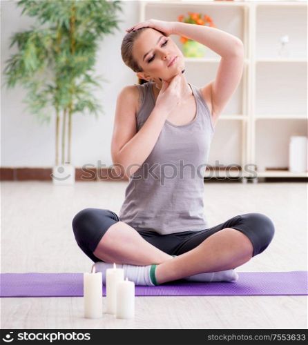 The young woman exercising in sports hall in healthy concept. Young woman exercising in sports hall in healthy concept