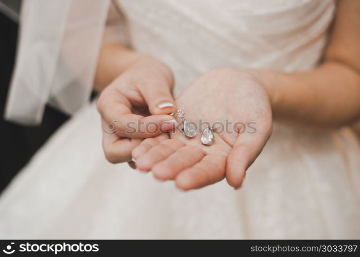 The young woman holds ornaments which is going to put on wedding.. The bride shows ornaments.