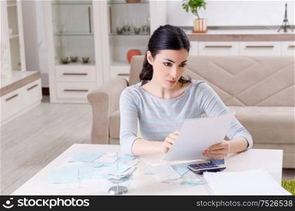 The young woman in budget planning concept. Young woman in budget planning concept