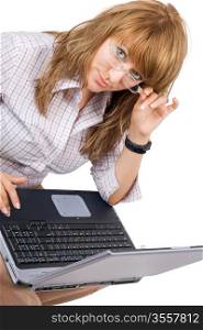 The young woman in glasses sits with the laptop. Isolated