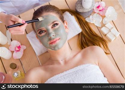 The young woman in spa health concept with face mask. Young woman in spa health concept with face mask