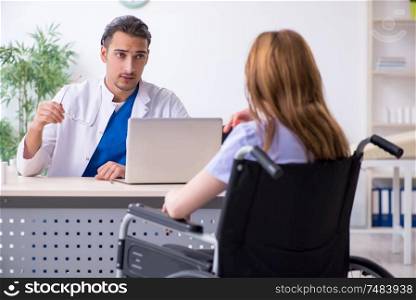 The young woman in wheel-chair visiting male doctor . Young woman in wheel-chair visiting male doctor