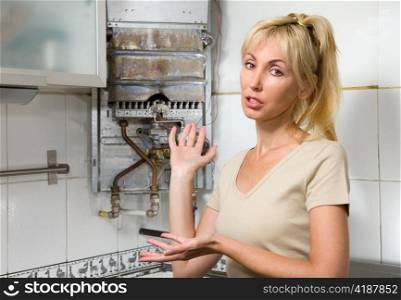 The young woman is upset by that the gas water heater has broken
