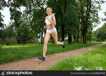 The young woman makes jog in morning park