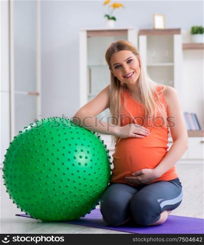 The young woman preparing for birth exercising at home. Young woman preparing for birth exercising at home