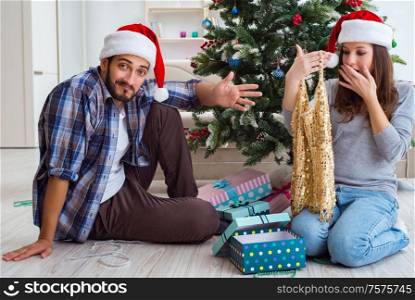 The young woman receiving dress as christmas gift. Young woman receiving dress as christmas gift