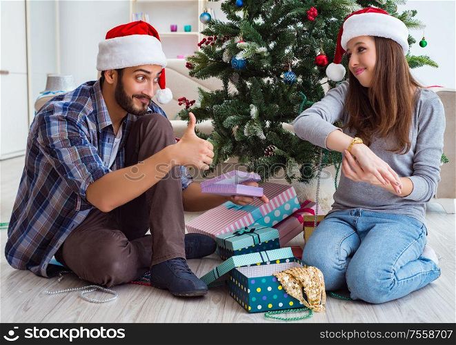 The young woman receiving gold watch as christmas gift. Young woman receiving gold watch as christmas gift