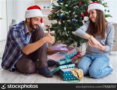 The young woman receiving gold watch as christmas gift. Young woman receiving gold watch as christmas gift