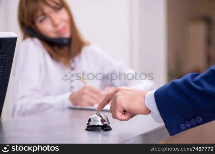 The young woman receptionist at hotel reception. Young woman receptionist at hotel reception