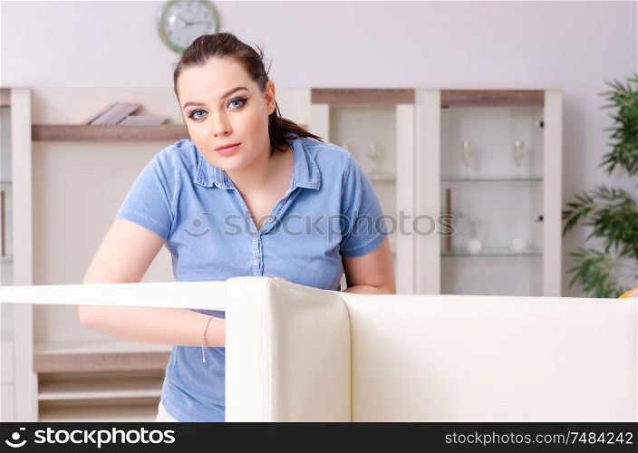 The young woman repairing chair at home. Young woman repairing chair at home