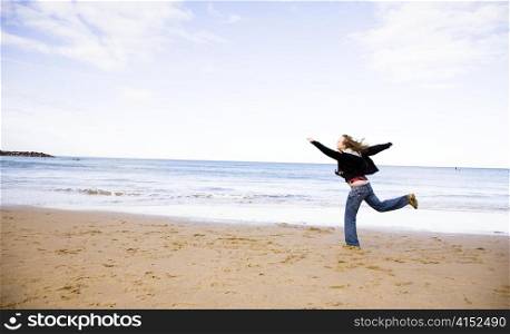 The Young Woman Running On A Beach
