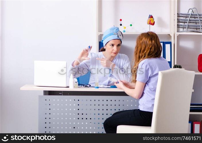 The young woman visiting female doctor otolaryngologist. Young woman visiting female doctor otolaryngologist