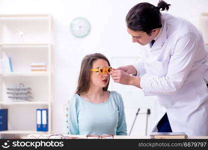 The young woman visiting male doctor oculist . Young woman visiting male doctor oculist 