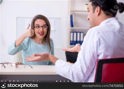 The young woman visiting male doctor oculist . Young woman visiting male doctor oculist 
