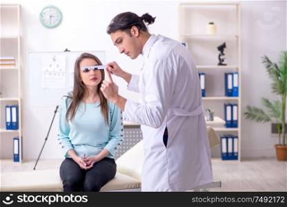The young woman visiting male doctor oculist. Young woman visiting male doctor oculist