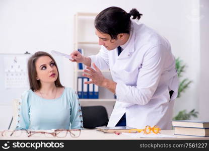 The young woman visiting male doctor oculist. Young woman visiting male doctor oculist