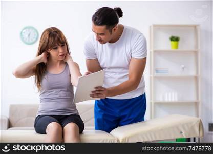 The young woman visiting male doctor physiotherapist. Young woman visiting male doctor physiotherapist