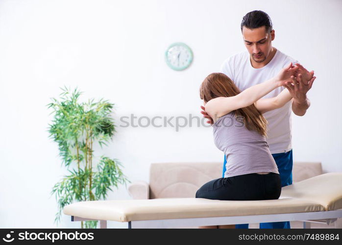 The young woman visiting male doctor physiotherapist. Young woman visiting male doctor physiotherapist