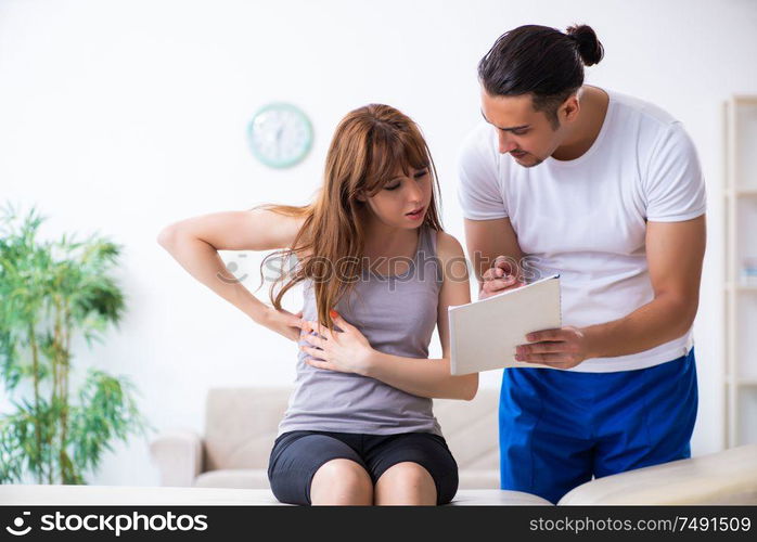 The young woman visiting male doctor physiotherapist. Young woman visiting male doctor physiotherapist