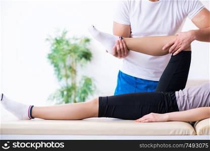 The young woman visiting male doctor physiotherapist. Young woman visiting male doctor physiotherapist