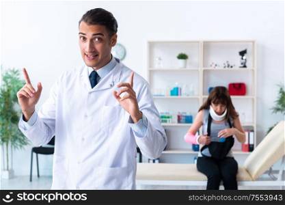 The young woman visiting male doctor traumatologist. Young woman visiting male doctor traumatologist