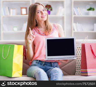 The young woman with shopping bags indoors home on sofa. Young woman with shopping bags indoors home on sofa