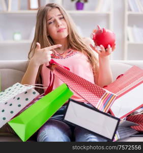 The young woman with shopping bags indoors home on sofa. Young woman with shopping bags indoors home on sofa